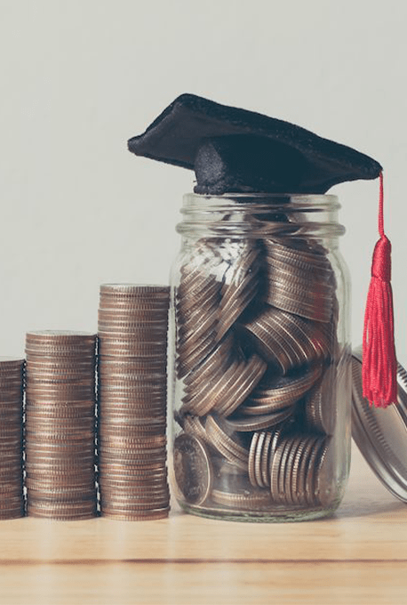 Image of jar with money in it and a graduation hat on top